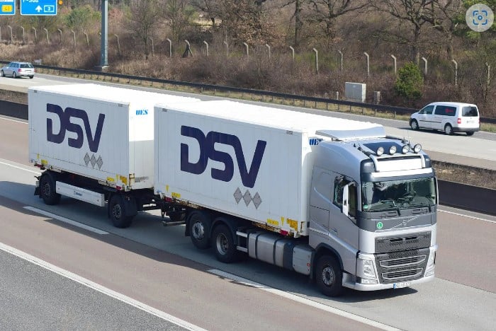 DSV truck and trailer driving on a motorway type road.