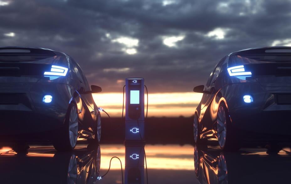 two electric vehicles, one is charging