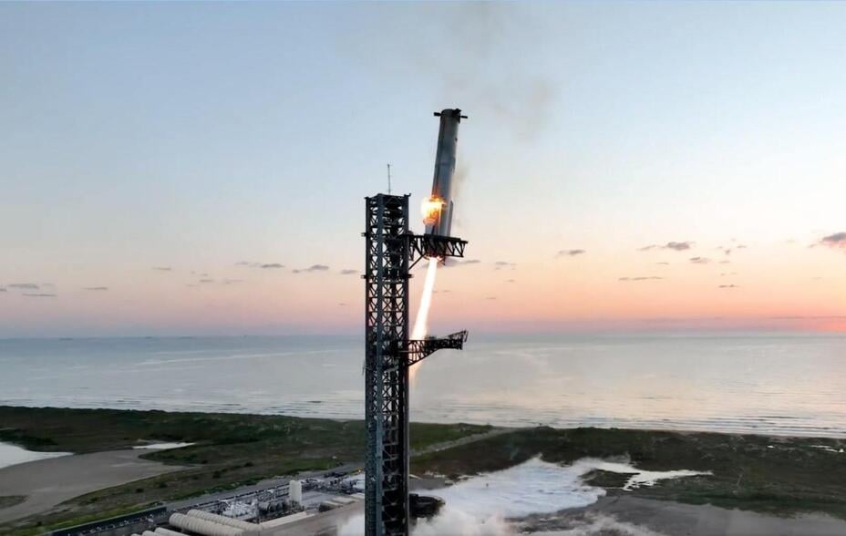 Starship's Super Heavy rocket booster is caught mid-air during the fifth flight test in Texas