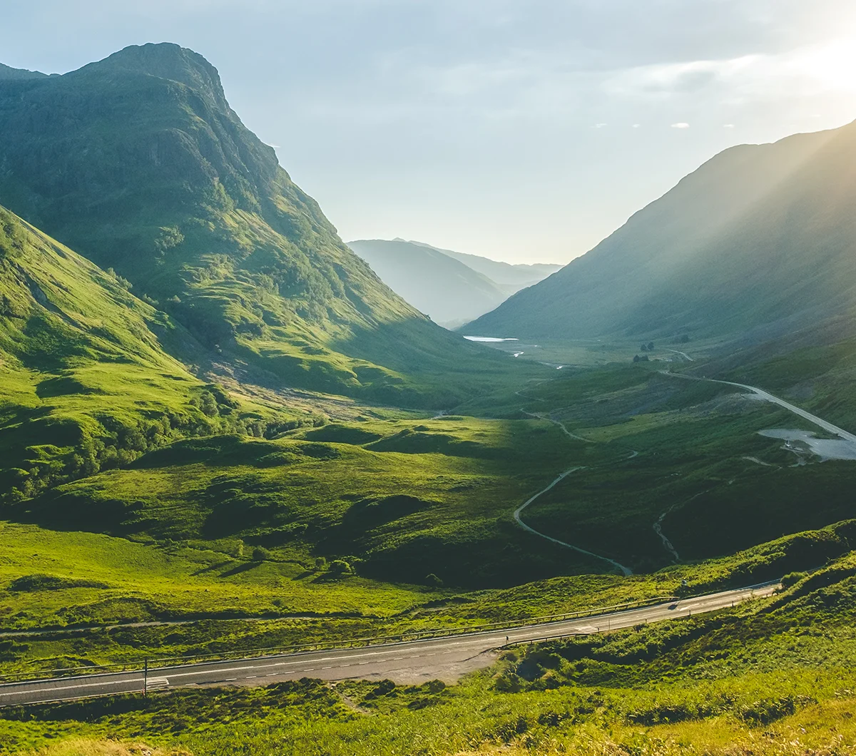 The sun shines through Glencoe, Scotland
