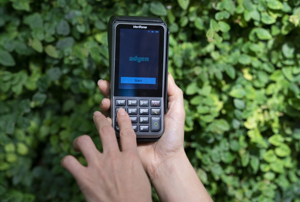 two hands holding a card machine