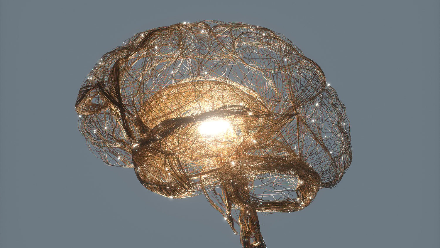 Computer generated render of nerves forming the structure of a brain with a bright light in the centre.