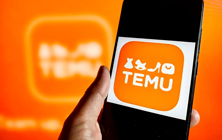 Orange Temu logo on phone screen with orange background
