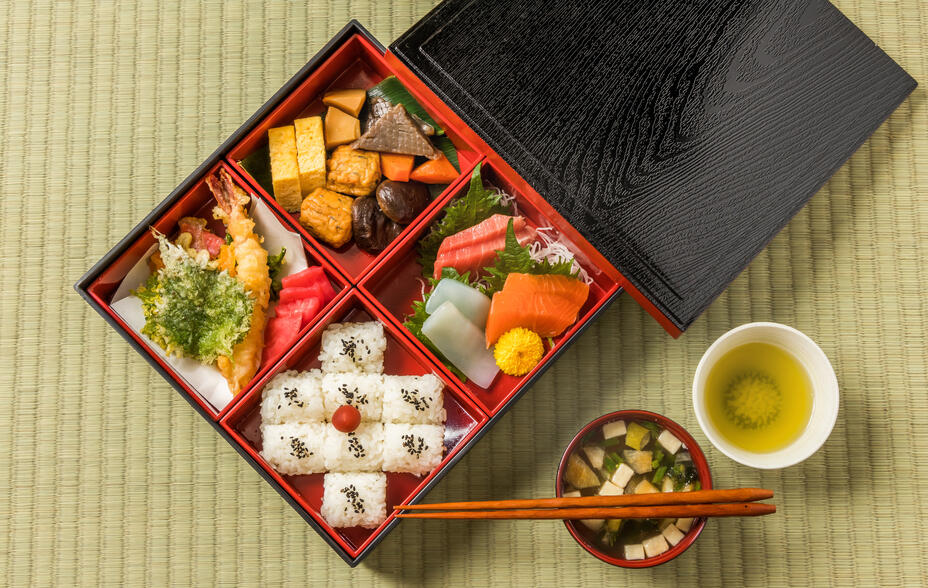 A beautifully arranged Japanese bento box filled with carefully selected, artfully presented dishes.