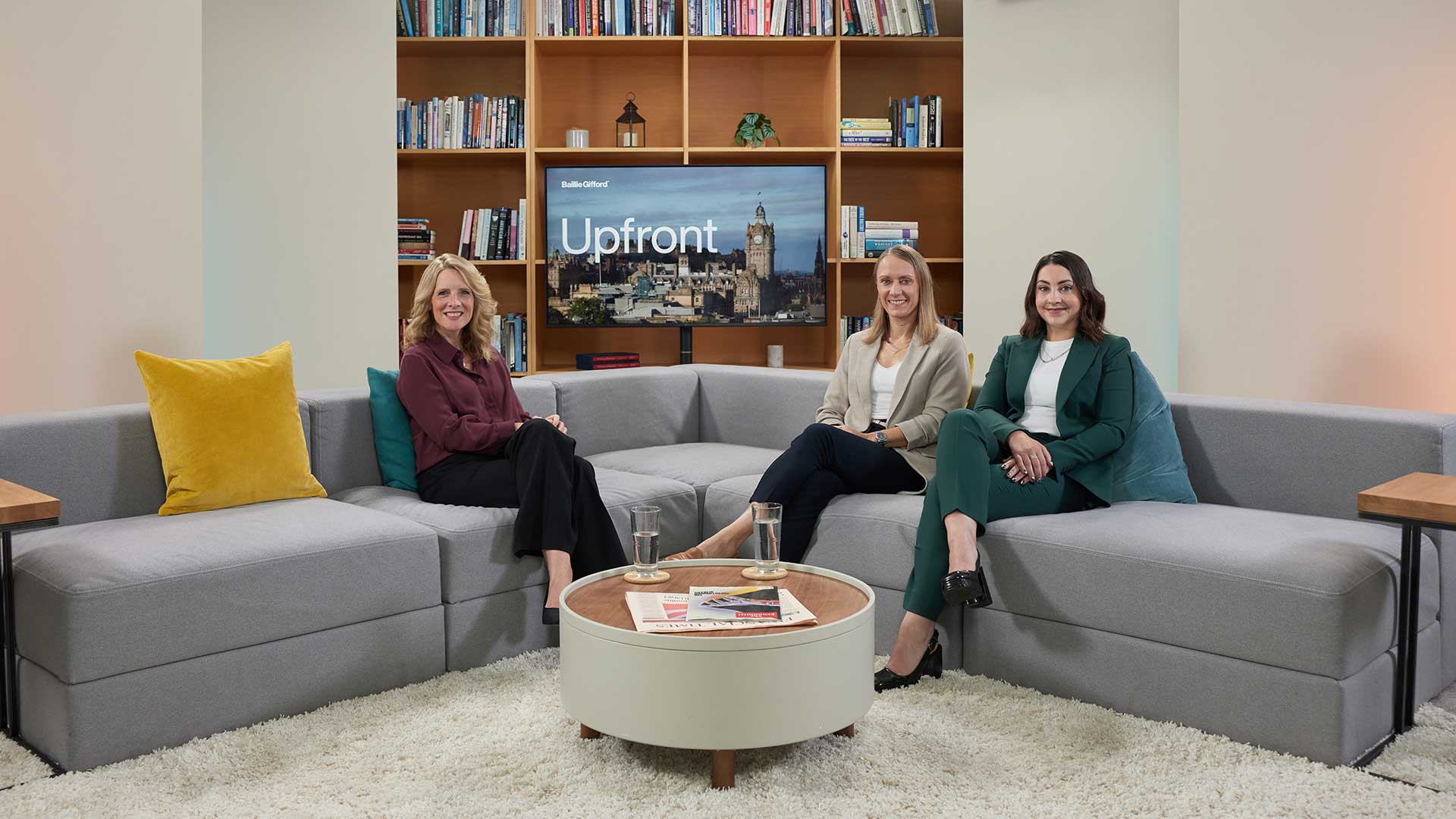 Cherry Reynard, Lesley Dunn and Megan Rooney sat on a corner sofa looking directly at the camera.