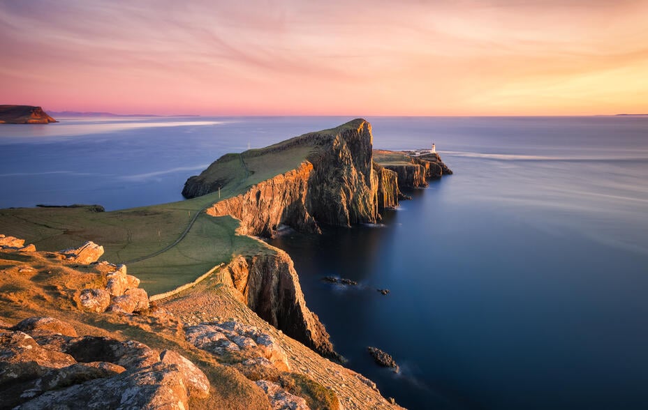 Sunset over the Neist Point Lighthouse, Isle of Skye, Scotland, UK. Neist Point (Scottish Gaelic: Rubha na h-Eist) is a viewpoint on the most westerly point of Skye. Neist Point Lighthouse has been located there since 1909. Neist Point is the most westerly point on the Duirinish peninsula on the Isle of Skye. It projects into The Minch and provides a walk and viewpoint.